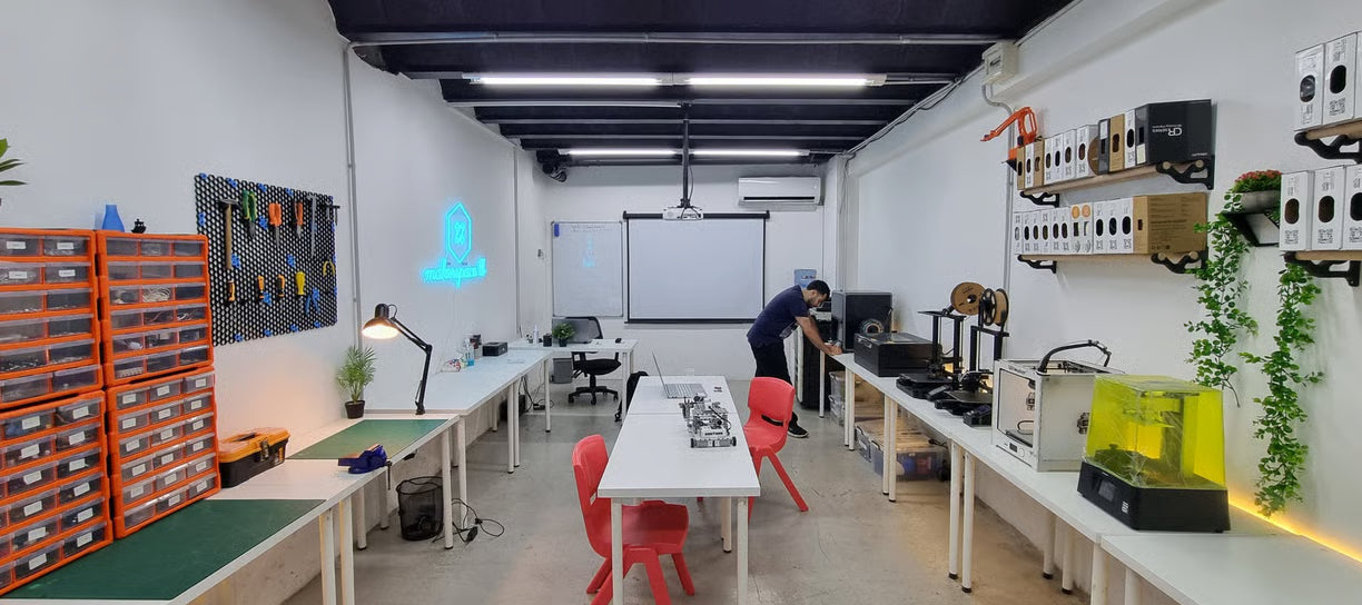 Workshop or lab with tables, chairs, and various equipment.